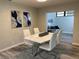 Elegant dining room featuring a modern table with white chairs and tasteful wall decor at 692 Augusta Rd, Winter Haven, FL 33884