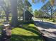 Community entrance featuring a guard house, well-manicured lawn and trees, enhancing curb appeal at 692 Augusta Rd, Winter Haven, FL 33884