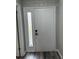 Front door with wood-look flooring and sidelight pane on the door at 692 Augusta Rd, Winter Haven, FL 33884