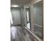 Hallway with modern mirrors, leading to the bedrooms and entryway at 692 Augusta Rd, Winter Haven, FL 33884