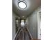 Long hallway leads to the main living area, with sleek mirrors along the wall at 692 Augusta Rd, Winter Haven, FL 33884