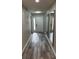 Well-lit hallway with sleek mirrors adding depth and style, with an entry door at 692 Augusta Rd, Winter Haven, FL 33884