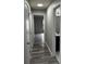 Hallway view of modern gray flooring and open doorways to other rooms at 692 Augusta Rd, Winter Haven, FL 33884