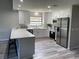 Stylish kitchen with modern appliances, white cabinets, and a large island with bar seating at 692 Augusta Rd, Winter Haven, FL 33884