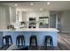 Modern kitchen featuring white cabinetry, stainless steel appliances, and a stylish breakfast bar at 692 Augusta Rd, Winter Haven, FL 33884