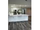 Kitchen features a large quartz countertop island with stainless appliances and gray wood floors at 692 Augusta Rd, Winter Haven, FL 33884