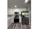 Kitchen features stainless steel appliances, white cabinets, and light quartz countertops at 692 Augusta Rd, Winter Haven, FL 33884