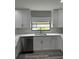 Kitchen sink with stainless steel appliances and shaker cabinets at 692 Augusta Rd, Winter Haven, FL 33884