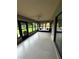 Bright lanai showcasing tiled flooring, expansive windows, and a cozy sofa for relaxing at 692 Augusta Rd, Winter Haven, FL 33884