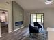 Cozy living room with modern fireplace and a sitting area with comfortable blue chairs at 692 Augusta Rd, Winter Haven, FL 33884
