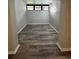 Open living room area featuring hardwood flooring, recessed lighting, and natural light at 692 Augusta Rd, Winter Haven, FL 33884
