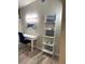 Bright office space featuring a modern desk and ladder shelf for storage at 692 Augusta Rd, Winter Haven, FL 33884