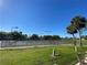 Well-maintained community tennis courts surrounded by green lawns and palm trees at 692 Augusta Rd, Winter Haven, FL 33884