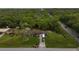 Aerial view of a single-Gathering home surrounded by trees, with an RV parked in the driveway at 6940 Newman E Cir, Lakeland, FL 33811