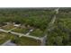 An aerial view of a home near a highway surrounded by dense trees at 6940 Newman E Cir, Lakeland, FL 33811