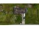 Overhead view of home with a large yard, several vehicles, and an RV parked in the driveway at 6940 Newman E Cir, Lakeland, FL 33811