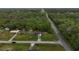 An aerial view of a home near a highway surrounded by dense trees at 6940 Newman E Cir, Lakeland, FL 33811