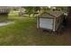 A single-car outbuilding sitting on a large grassy lot with a big shade tree at 6940 Newman E Cir, Lakeland, FL 33811