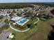 Aerial view of community pool, tennis court, and surrounding homes at 726 Chacall Loop, Mount Dora, FL 32757