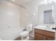 Clean bathroom with a shower-tub combo, classic white tile, and modern vanity at 726 Chacall Loop, Mount Dora, FL 32757