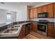 Well-equipped kitchen featuring stainless steel appliances, modern cabinetry, and a stylish backsplash at 726 Chacall Loop, Mount Dora, FL 32757