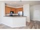 Well-lit kitchen featuring wood cabinets, stainless steel appliances, and a stylish breakfast bar area at 726 Chacall Loop, Mount Dora, FL 32757