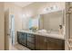 Well-lit bathroom with double sinks, granite counters, and large mirror at 7289 Liberty Rd, Lakeland, FL 33809