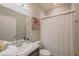 Bathroom with white shower curtain, sink, decor, and towel rack at 7289 Liberty Rd, Lakeland, FL 33809