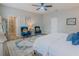 Bedroom featuring neutral walls, ceiling fan, sitting area, ensuite bath and wood-look floors at 7289 Liberty Rd, Lakeland, FL 33809