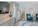 Bedroom featuring wood-look floors, neutral walls, and a sitting area with blue chairs at 7289 Liberty Rd, Lakeland, FL 33809