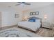 Bright bedroom featuring wood-look floors, neutral walls, and a stylish upholstered bed frame at 7289 Liberty Rd, Lakeland, FL 33809