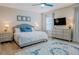 Bedroom with wood-look floors, rug, fan, and matching dressers and nightstands at 7289 Liberty Rd, Lakeland, FL 33809