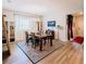 Dining room with wood table, chairs, white curtains, and an entryway leading to the hall at 7289 Liberty Rd, Lakeland, FL 33809