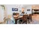 Elegant dining room featuring wooden furniture, a world map, and an adjacent kitchen at 7289 Liberty Rd, Lakeland, FL 33809