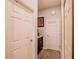 Neutral hallway with white doors, gray walls, decorative clock, and a convenient storage area at 7289 Liberty Rd, Lakeland, FL 33809