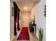 Inviting entryway with a red rug, table, and unique theater-themed decor at 7289 Liberty Rd, Lakeland, FL 33809