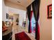 View of the hallway with a decorative table, hardwood floors and theater-themed curtains at 7289 Liberty Rd, Lakeland, FL 33809