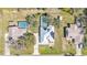 Aerial view of a home with metal roof, solar panels, swimming pool and long driveway at 8621 Plantation Ridge Blvd, Lakeland, FL 33809