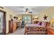 Inviting bedroom with a ceiling fan, decor and a view of the outdoor greenery at 8621 Plantation Ridge Blvd, Lakeland, FL 33809