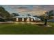 Well-maintained home exterior featuring a metal roof, stone accents and a lovely front yard at 8621 Plantation Ridge Blvd, Lakeland, FL 33809