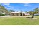 Charming single-story home featuring stone accents, a metal roof, and a well-manicured lawn at 8621 Plantation Ridge Blvd, Lakeland, FL 33809