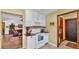 Cozy kitchen with white cabinetry and appliances, flowing into the adjacent living room at 8621 Plantation Ridge Blvd, Lakeland, FL 33809