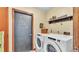 Convenient laundry room featuring updated appliances and a charming chalkboard door at 8621 Plantation Ridge Blvd, Lakeland, FL 33809