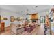 Warm living room featuring a stone fireplace, hardwood floors, and comfortable seating arrangement at 8621 Plantation Ridge Blvd, Lakeland, FL 33809