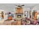 Inviting living room with a stone fireplace, hardwood flooring, and cozy, plush leather furniture at 8621 Plantation Ridge Blvd, Lakeland, FL 33809