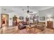 Open-concept living room featuring hardwood floors, a stone fireplace, and a welcoming layout at 8621 Plantation Ridge Blvd, Lakeland, FL 33809