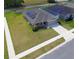 Charming single-story home featuring solar panels, a well-manicured lawn, and a convenient two-car garage at 937 Montgomery Ln, Polk City, FL 33868