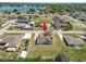 Suburban home featuring a large backyard, covered patio, driveway, and a view of a tranquil lake nearby at 124 Brandy Chase Blvd, Winter Haven, FL 33880