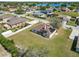 Home with solar panels and covered patio situated on a spacious lot with a view of a tranquil lake nearby at 124 Brandy Chase Blvd, Winter Haven, FL 33880