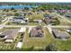 Suburban home featuring a large backyard, covered patio, driveway, and a view of a tranquil lake nearby at 124 Brandy Chase Blvd, Winter Haven, FL 33880